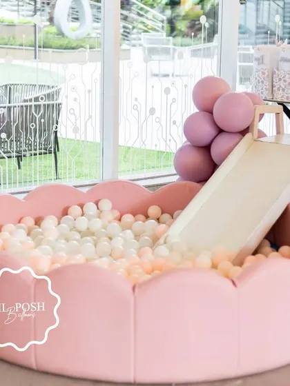 The soft pink, flower-shaped ball pit with a slide was a huge hit at Aahana's "Onderland" first birthday party.