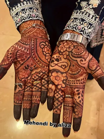 A mature henna stain after a few days. You can see the deep, almost black color that my organic henna achieves. This design also features a cute paw print for a pet lover.