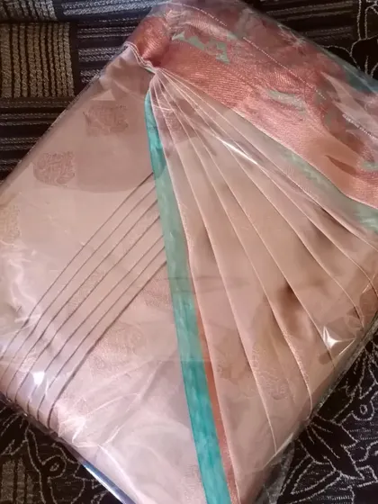 This saree is pre-pleated and box-folded, ready for a client. This method ensures the pleats stay crisp and the saree remains wrinkle-free.