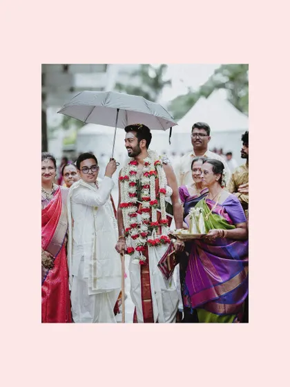 The groom's procession, where he is escorted under an umbrella as part of the 'kashi yatra' ritual.