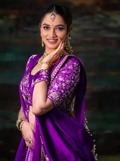 A final shot of the expo look, showing how the turquoise kajal, purple lehenga, and gold jewellery all work together beautifully.