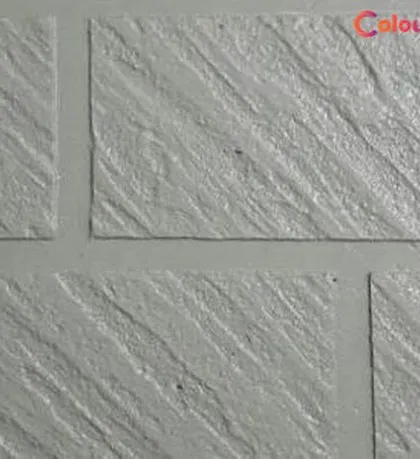 A close-up of a premium exterior texture that mimics the look of cut stone. This durable, trowel-applied finish is perfect for adding a stately and permanent look to a building's facade.