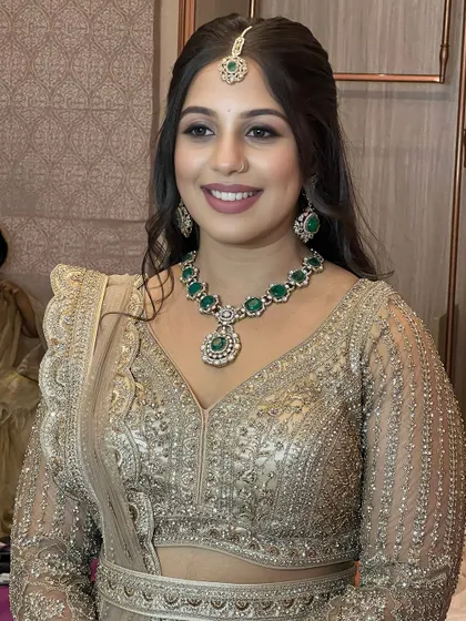 This smiling portrait captures the essence of a fun, celebratory look. The makeup is designed to be long-lasting and look great both in person and in photos.