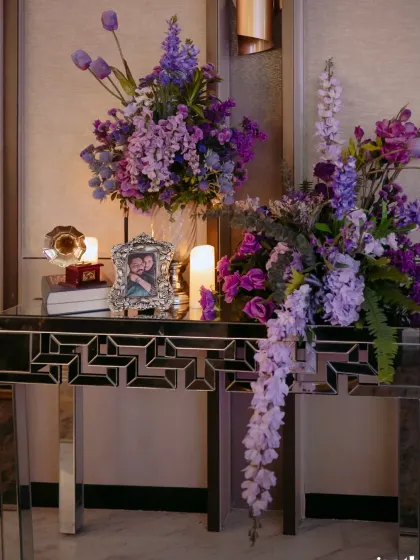 An elegant floral arrangement in shades of purple and lavender sits on a mirrored console table. This was part of the decor for a vintage themed welcome soirée in Goa.
