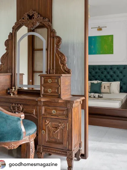 This vintage-inspired vanity, separated from the master bedroom by an ombre glass partition, is a perfect example of classic elegance. The intricate carvings and rich wood finish add a touch of old-world charm and create a dedicated, luxurious space for getting ready.