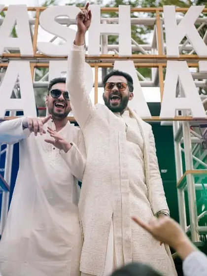 The groom and his friends on top of the "Yash Ki Baraat" truck, a fun and unique baraat idea.