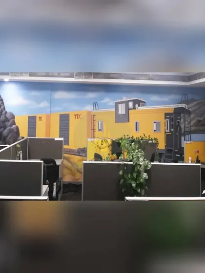 We painted this mural of a yellow train caboose to transform an office space in Gurgaon. This creative theme turns a standard cubicle area into a unique and imaginative environment.