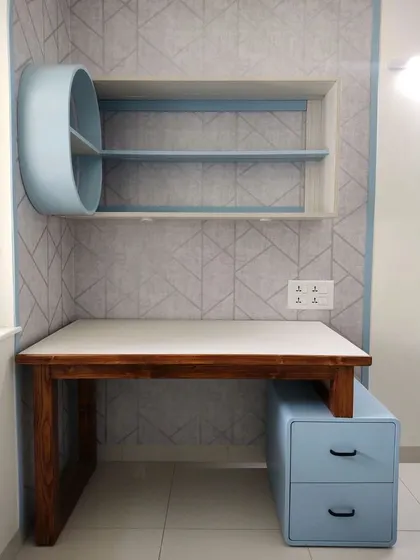 Another view of the compact and stylish work-from-home corner in the bedroom, featuring a desk, drawers, and overhead storage.
