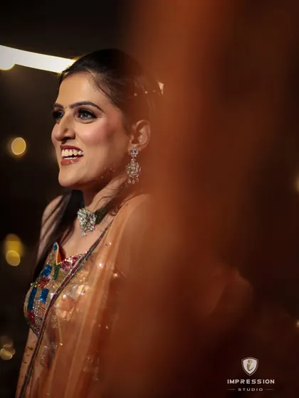 A candid shot of the bride at her mehndi, her radiant smile lighting up the frame.