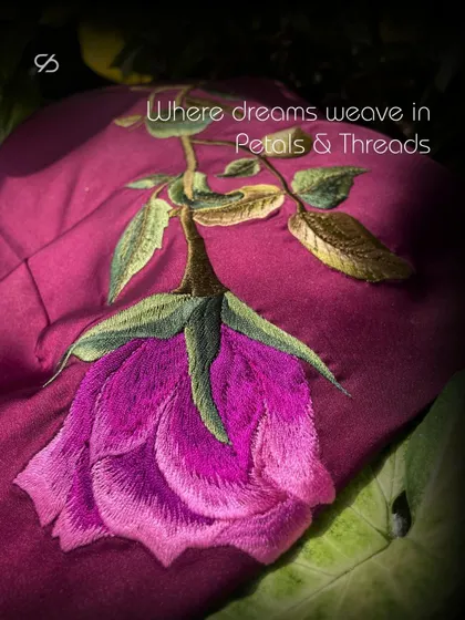 Lost in the enchantment of petals and threads, where dreams bloom into delicate stitches. This image captures a single, beautifully rendered rose, showcasing the art of machine embroidery.