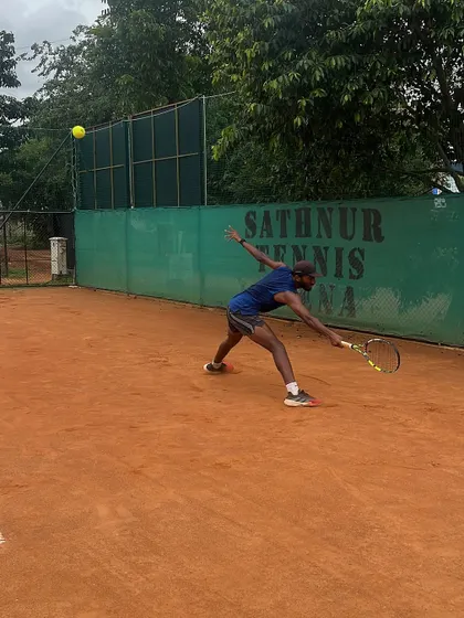 Rishi Reddy lunging for a low ball during an intense practice session. Training on clay courts helps develop stamina, strategy, and the ability to slide into shots effectively.