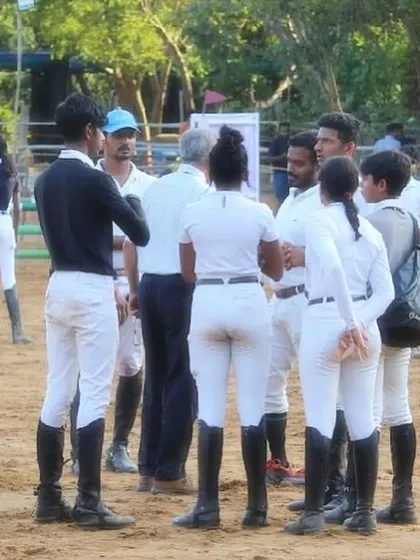 My team discussing strategy at the Auroville Horse Show. Success in this sport is a team effort, involving riders, coaches, and grooms working together.