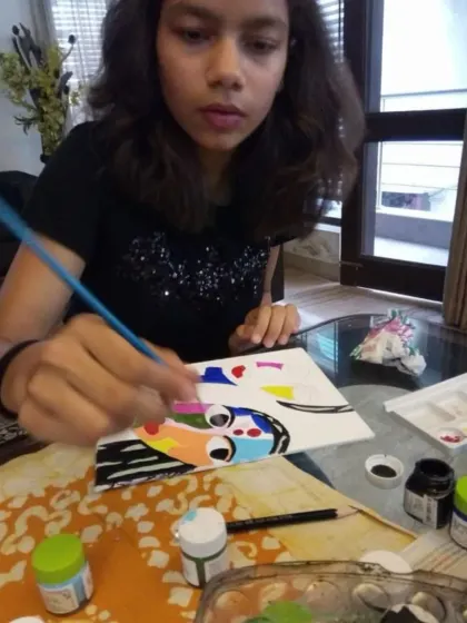 A student adds the final touches to her Picasso-inspired abstract face. Our classes often explore the styles of great masters to help children discover new ways of seeing and creating.