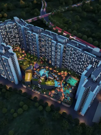 An aerial night view rendering of the Kohinoor Uptown township in Kalyan. This perspective shows how we integrate buildings with extensive landscaped areas, pools, and recreational zones to create a complete living environment.