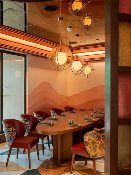 A private dining corner at Comorin. We focused on the unique chairs and elegant table setting to showcase the restaurant's suitability for intimate gatherings and special occasions.