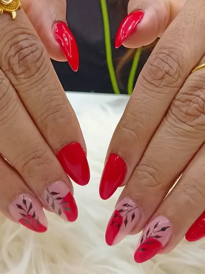 The complete look of the striking red and black leaf-art manicure.