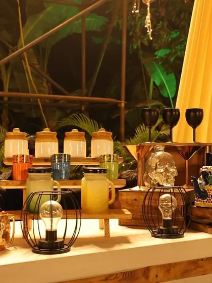 A quirky and eclectic bar setup perfect for a themed party. We used interesting props like a skull-shaped glass, a painted teapot, and unique lanterns to create a memorable and talk-worthy drink station.