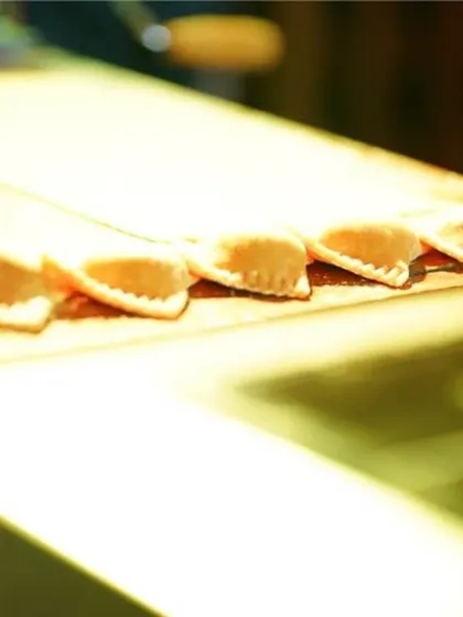 A close-up of our handmade pasta, ready to be cooked to order at a live station. This showcases our commitment to fresh ingredients and authentic preparation methods, just like in our restaurant.