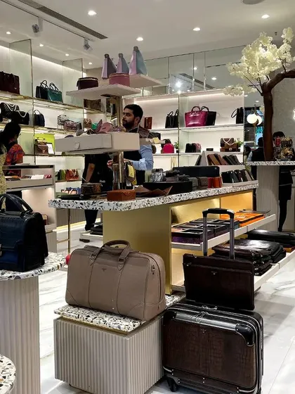 A shot of the busy Da Milano interior, showing the central display tables and the cash counter area with its decorative tree feature.