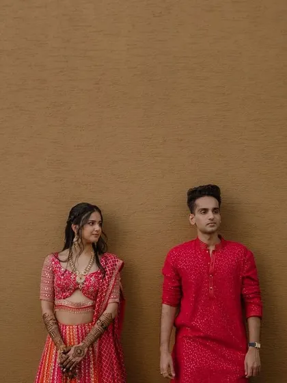 A minimalist and modern pre-wedding portrait. The simple background and contrasting colors of their outfits make this a bold and stylish shot.