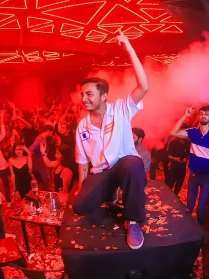 Surrounded by red lights and CO2 smoke, I love getting right into the middle of the action. This is me on top of a speaker, making sure the energy reaches every corner of the club.