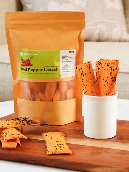A product-focused shot of the red pepper lavash, with the packaging clearly visible and the crackers displayed invitingly.