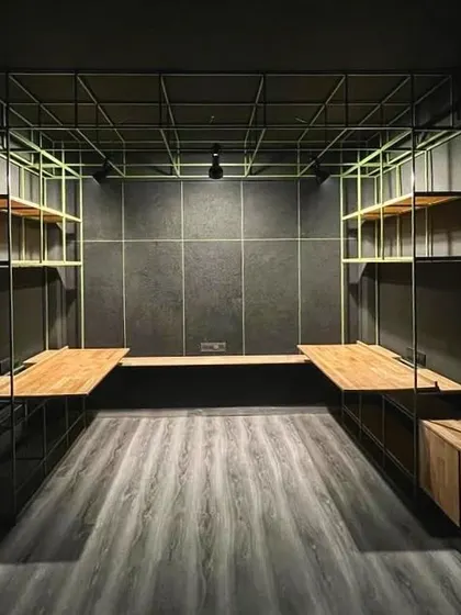 This micro-studio in Hauz Khas demonstrates our approach to maximizing small volumes. A lightweight metal grid structure functions as a ceiling, shelving, and desk support system, creating a fully integrated and efficient workspace within a compact footprint.