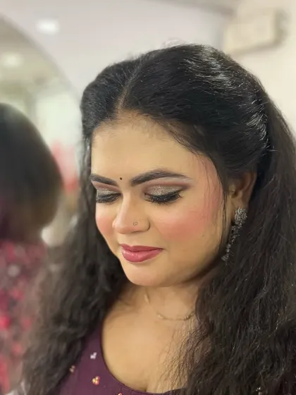 A close-up with eyes closed to showcase the soft, shimmery eyeshadow. This kind of detail is perfect for a glamorous evening look.