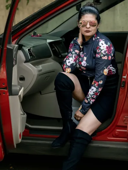 A close-up of the floral top and boots combination. The key is to balance the different elements to create a cohesive and powerful look.