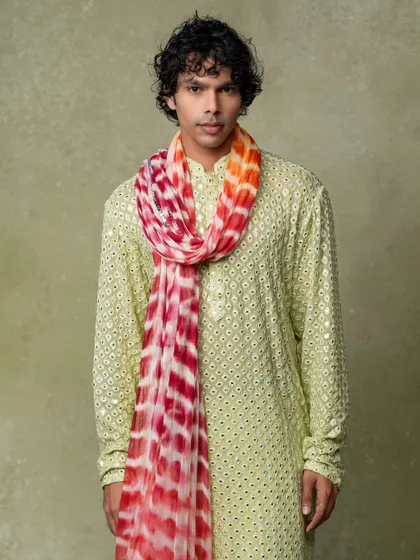 A clean and vibrant studio shot for a men's ethnic wear brand. The focus is on the modern design and bright colors of the outfit.