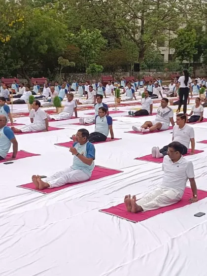 A large group of participants practicing a seated forward bend during our Delhi event. The uniformity of the practice creates a beautiful visual of collective mindfulness.