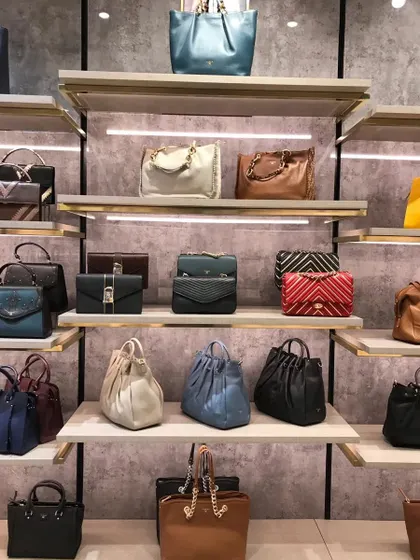 A wall display of handbags, showing how we use texture and lighting to create an attractive backdrop for the products.