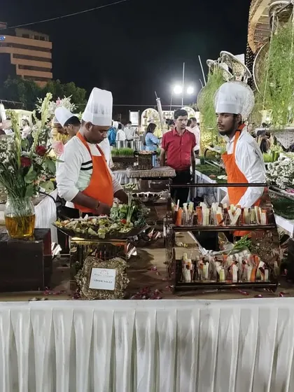 My chefs are seen here adding the final touches to a salad station, ensuring everything is perfect for a wedding reception.