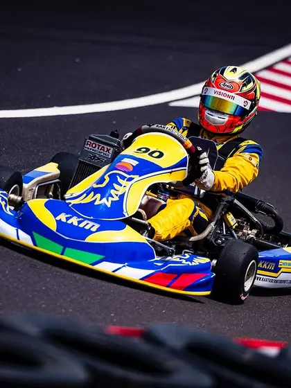 Our driver in the number 90 kart, taking a corner with speed and precision.