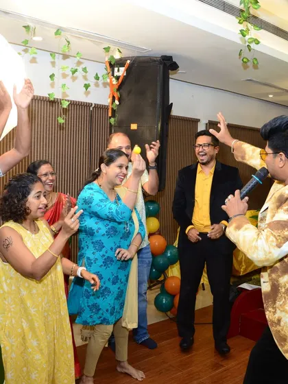 A group of guests enjoying an interactive game at a private celebration. My focus is on creating a lively atmosphere where everyone feels comfortable joining in.
