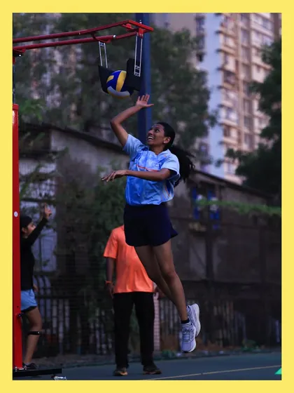 A young spiker practices her arm swing and jump using our specialized equipment. This tool helps players develop power and accuracy safely.