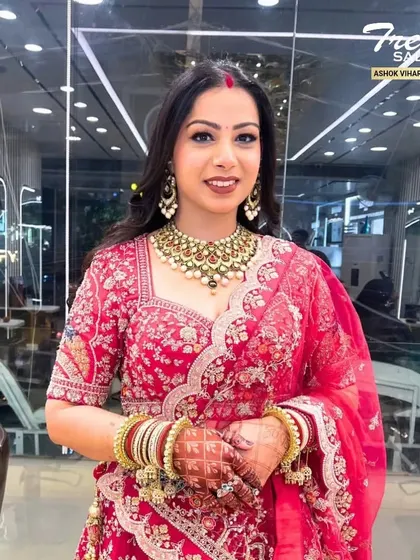A radiant smile completes any bridal look. This photo captures the finished makeup, showcasing the glowing skin and how the entire look comes together with her jewelry and outfit.