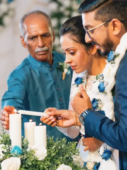 A sacred moment from Rijo and Gigi's wedding ceremony, as they light the unity candle with a family member, symbolizing the joining of two families.
