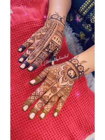 A beautiful combination of traditional motifs, with an elephant in a central mandala on one hand and intricate line work on the other.