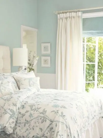 A bright and airy bedroom painted in a soft, sky blue. This color creates a tranquil and refreshing atmosphere, making the room feel open and connected to the outdoors.