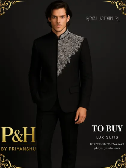 Power and elegance converge in this royal black Jodhpuri suit. The deep black fabric provides a dramatic canvas for the shimmering silver hand-embroidery that adorns the collar and front, creating a look of pure, unadulterated luxury for any formal occasion.