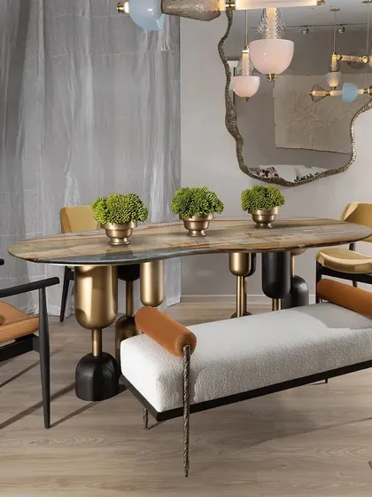 The Dining Bench from our Koko collection merges functionality with artistic design. The combination of soft bouclé fabric, solid teak wood trim, and intricately cast brass legs in a twisted fabric pattern creates a piece that is both comfortable and a true conversation starter.