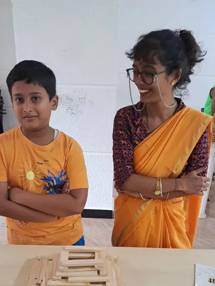 The pride of a young builder and the encouraging smile of a mentor. This is the supportive environment I aim to create, where children feel seen and celebrated for their creative efforts, boosting their confidence to try new things.
