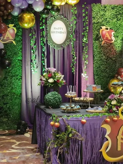 "Pick your poison." A wicked Descendants-themed birthday party, featuring a dessert table with a rich purple and green color scheme, poison apple motifs, and a spooky-chic vibe perfect for fans of the movie.