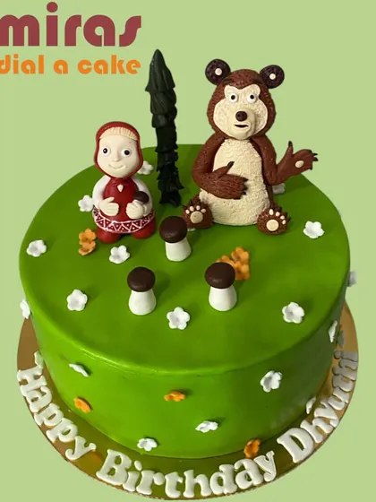 This Masha and the Bear cake captures the playful spirit of the animated series. The cake features hand-sculpted figurines of the mischievous Masha and her gentle bear friend in a forest setting.