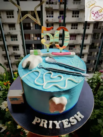 A sweet treat for the professional who fixes sweet tooths. This dentist-themed cake for a 50th birthday includes edible fondant teeth, dental tools, and floss, a fun nod to the recipient's profession.
