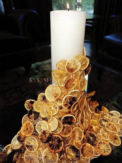 Where old meets new. I created this unique candle sculpture by adorning a simple pillar candle with a cascade of dried and toasted lemon slices, creating a beautiful play of texture and light.