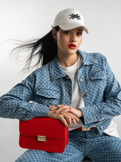 A denim-on-denim look from Benetton, styled with a pop of red for a modern, chic campaign image.