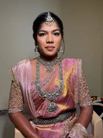 Lekhana's reception look. She wanted a matte eye with a glowing nude finish, and this look with her pink saree and silver jewellery is the beautiful result.
