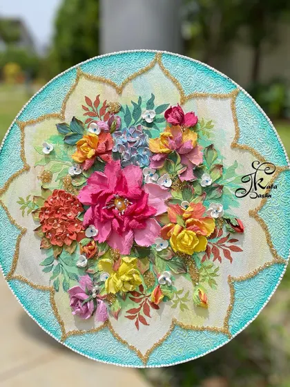 A 14-inch circular wall painting with a vibrant, multi-colored floral bouquet. The textured turquoise border with gold accents adds an elegant touch.